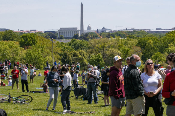 People gather to watch a fly over of the Blue Angels and Thunderbirds military planes in Washington DC on Saturday.