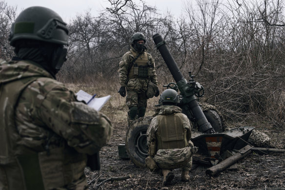 Volunteer soldiers prepare to fire towards Russian positions close to Bakhmut.