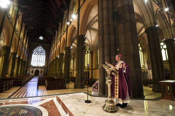 Archbishop Comensoli delivered last year’s Easter homily to an empty cathedral.
