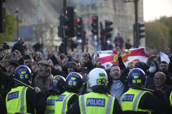 Counter-protesters confront police in Parliament Square.