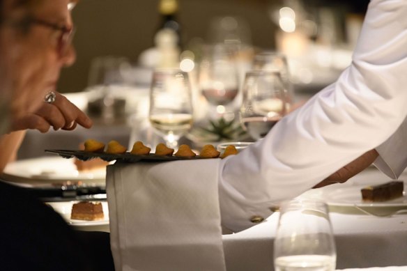 Table service and crisp, white uniforms.