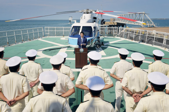 Japanese Prime Minister Shinzo Abe addresses sailors on a tour of a Japanese Coast Guard ship.