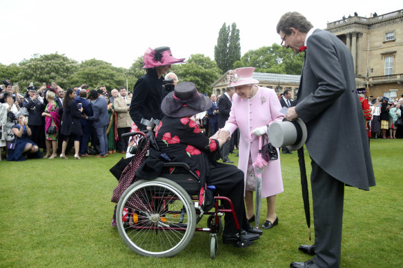 Queen Elizabeth meeting guests at the last Royal Garden Party at Buckingham Palace in May 2019.