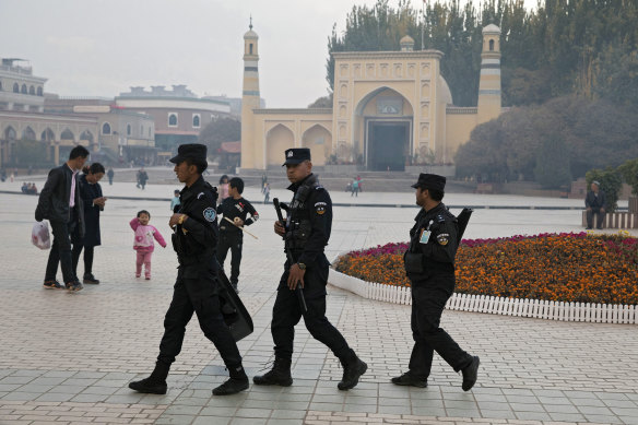 Uighur security personnel patrol near the Id Kah Mosque in Kashgar in western China's Xinjiang region in 2017. Uighurs live in a constant state of surveillance.