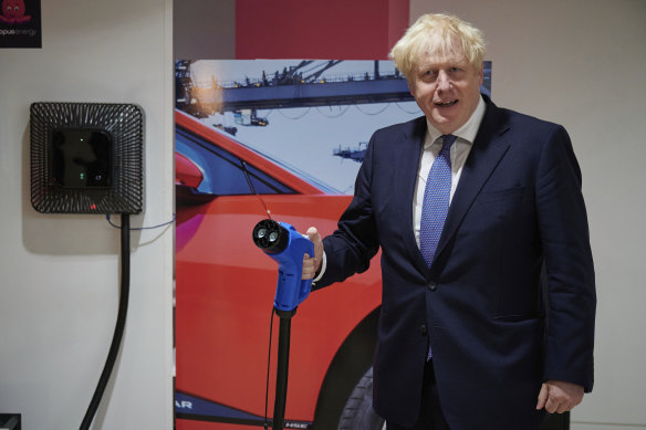 Britain's Prime Minister Boris Johnson holds an electric vehicle charging cable during a visit to the headquarters of Octopus Energy in London last month.