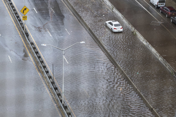 An abandoned car sits in flood waters on the FDR highway in the Lower East Side of Manhattan.