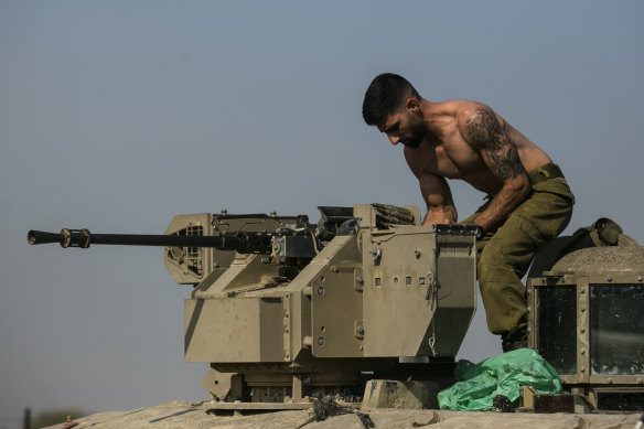 An Israeli soldier prepares a gun turret before entering the southern Gaza Strip.