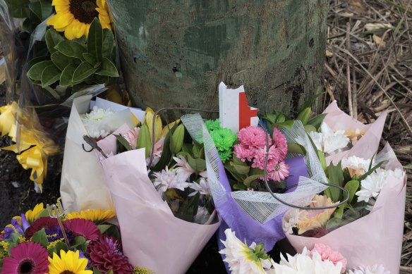Mourners placed flowers and a broken P plate at the scene of the crash in McGraths Hill. 