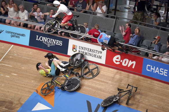 English cyclist Mall Walls (left) and Canadian Derek Gee crash into the crowd during the men’s 15km scratch race qualifying round.
