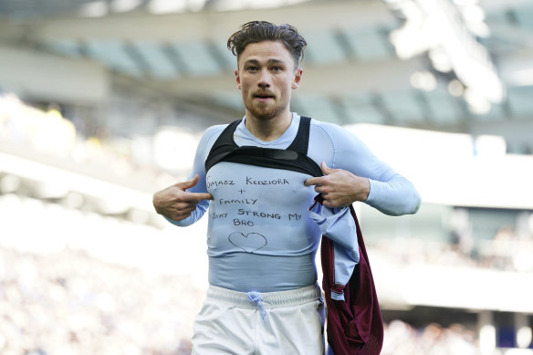 Aston Villa’s Matty Cash celebrates scoring against Brighton in the Premier League by revealing a shirt in support of his Polish compatriot Tomasz Kedziora, who plays for Dynamo Kyiv and remains in the Ukrainian capital with his family. 