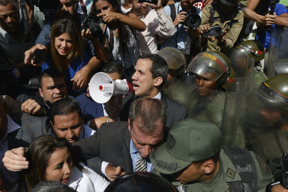 Venezuelan opposition leader Juan Guaido demands National Guard troops step aside and let him and his supporters into parliament.