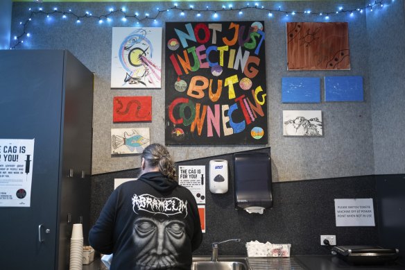 A user of the safe injecting room makes a coffee at the facility. 