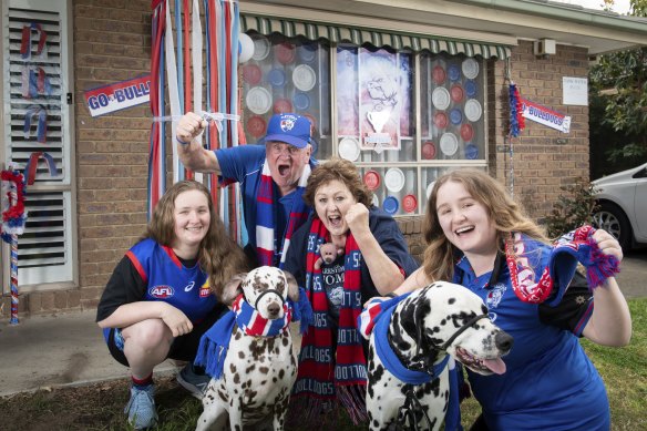 Doggies supporters Mikayla Royal  (right), her sister Mallory and parents Christine and Keith outside their Aspendale home. 