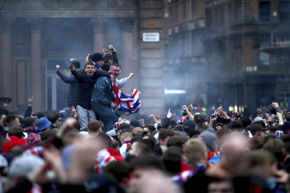 Soccer fans defy pandemic restrictions earlier this month to celebrate Glasgow Rangers winning the Scottish premiership.