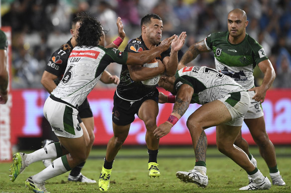 Indigenous All Star Corey Thompson takes on the Maori defence in Townsville last night. 