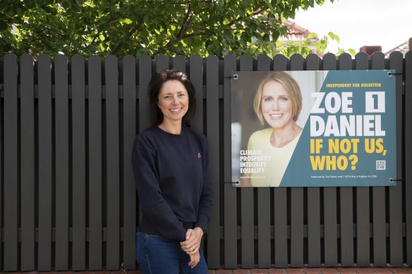 Hampton resident Lana Dacy with the Zoe Daniel campaign sign on her front fence. 