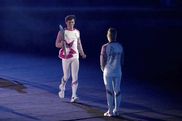 Tom Daley hands off the Commonwealth Baton to Alex Danson-Bennett during Thursday’s opening ceremony.