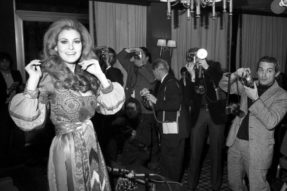 Raquel Welch posing for photographers in Paris in 1970.