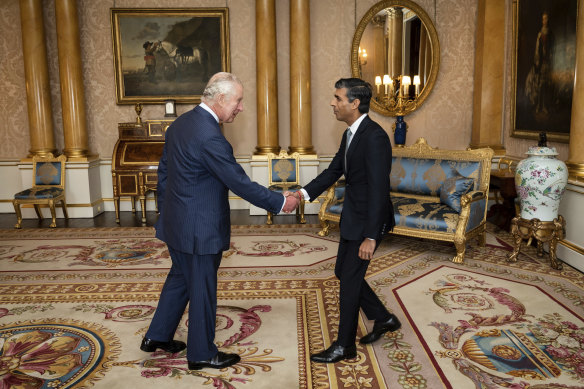 King Charles greets Rishi Sunak at Buckingham Palace.