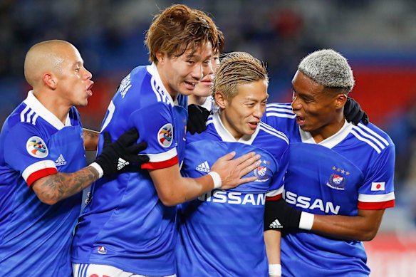 Yokohama F. Marinos celebrate a goal during their rampant win over Sydney FC. 
