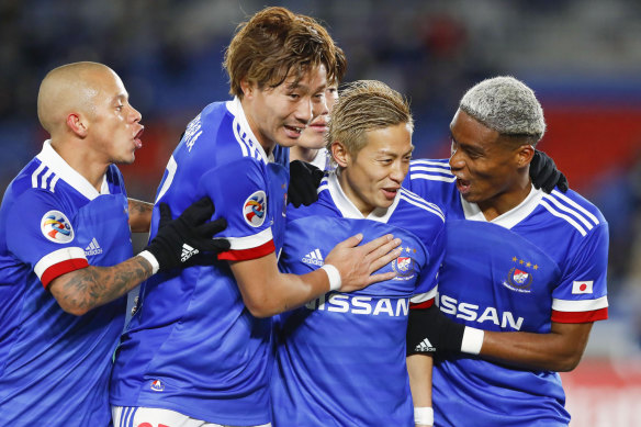 Yokohama F. Marinos celebrate a goal during their rampant win over Sydney FC. 