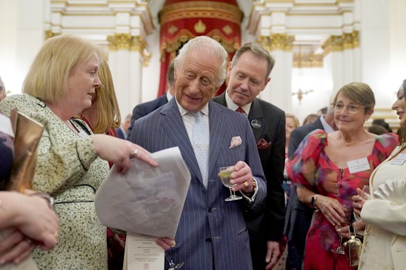 King Charles speaks to guests at the reception on Wednesday.
