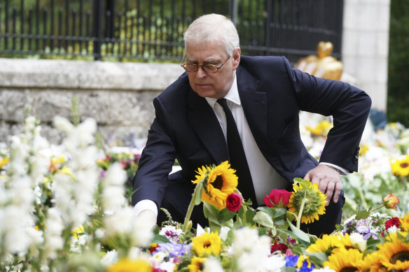 Britain’s Prince Andrew views the messages and floral tributes left by members of the public at Balmoral.