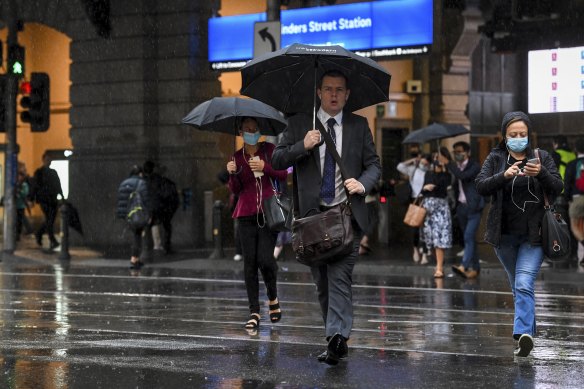 Umbrellas were out in force outside Flinders Street Station on Friday.