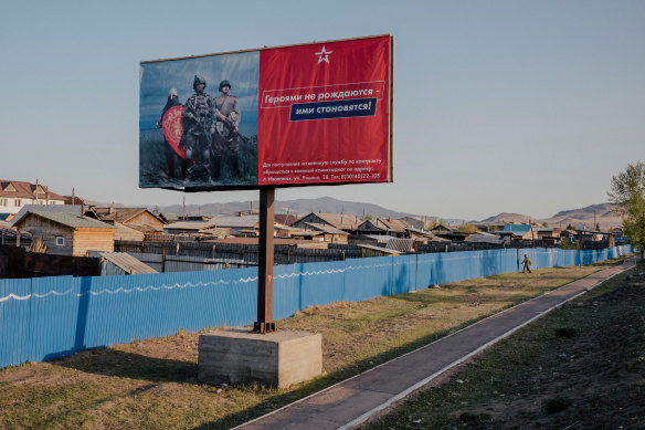 A Russian military recruitment billboard reads: “Heroes are not born, they are made.”
