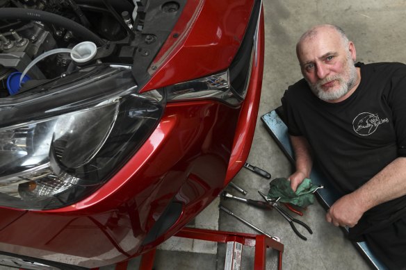 Mechanic Craig Bishop in his temporary workshop with no pits or hoists.