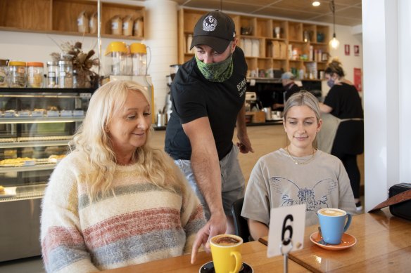 Beand Cafe owner Roy Farah serving coffees in  San Remo to Amanda Black and Louisa Pye.