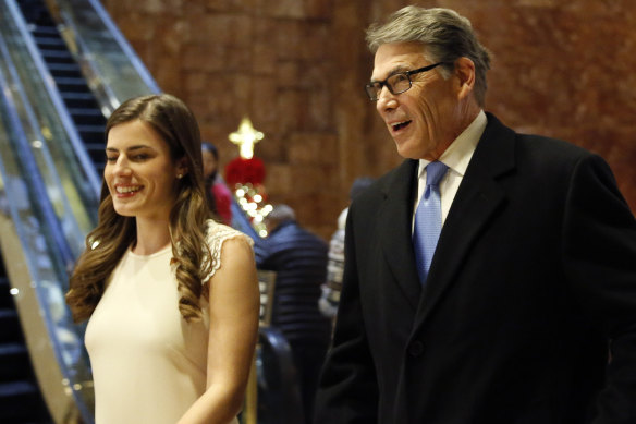 Former Texas governor Rick Perry  enters Trump Tower with Trump aide Madeleine Westerhout in 2016. 