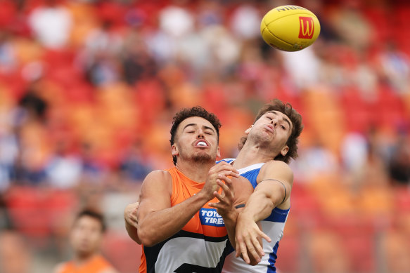 Jake Riccardi of the Giants is challenged by Kallan Dawson of the Kangaroos.