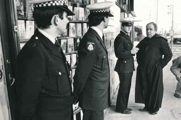 Father Anthony Bongiorno (right) speaks with police outside the bookshop in June 1980.