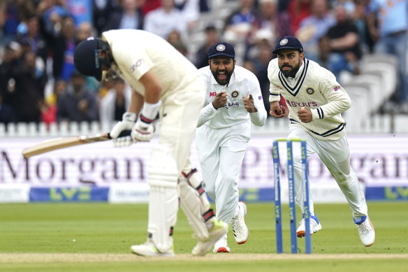 Indian skipper Virat Kohli (right) takes the catch to dismiss the in-form Joe Root.
