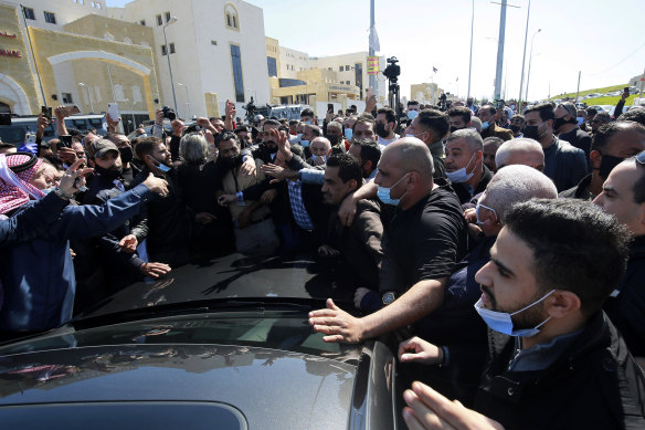 Angry people gather outside the Al-Hussein Al Salt Hospital.