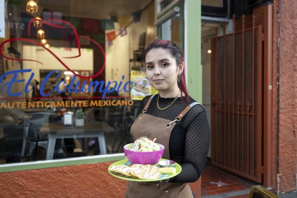 Valentina Morales with the pozole dish ouside El Columpio in Johnston Street.