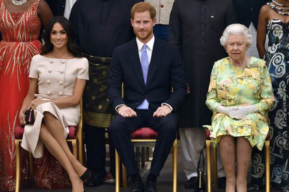 The Duke and Duchess of Sussex with the Queen at the Queen’s Young Leaders Awards ceremony at Buckingham Palace in London in 2018. 
