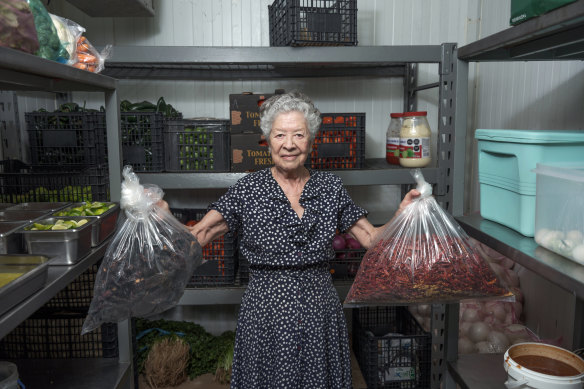 Guadalupe Carrillo holds bags containing dried chiles morita and chiles de árbol at Los Parados taqueria where she works in Mexico City.