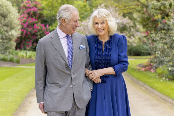 Britain’s King Charles III and Queen Camilla stand in Buckingham Palace Gardens the day after their 19th wedding anniversary. 