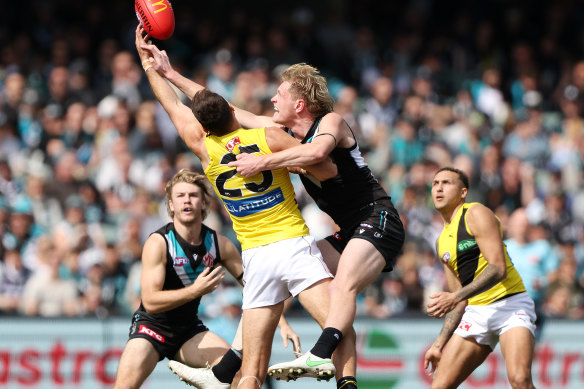 Port Adelaide’s Sam Hayes and Toby Nankervis of the Tigers do battle.