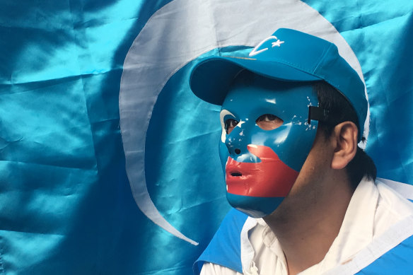An Uyghur human rights activist wears mask with the colours of the East Turkestan flag during a rally against the Chinese government in Osaka, Japan.