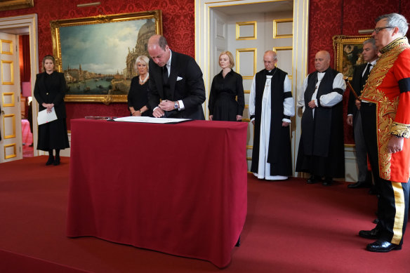 The Duke of Norfolk (far right) watches as Prince William signs the Proclamation of Accession of King Charles III.
