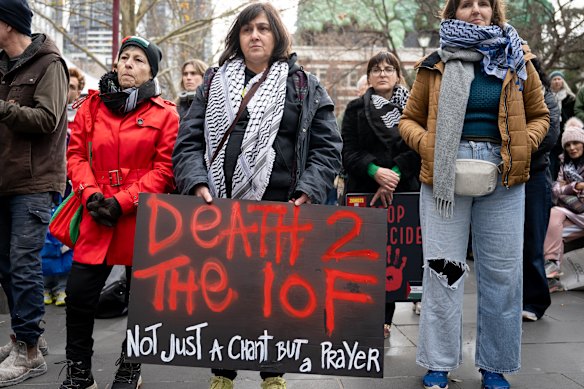 A protester holds a “Death 2 the IOF [Israeli occupation force]” sign.