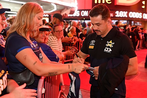 Reed Mahoney of the North Queensland Cowboys signs an autograph for a fan at the Fremont Street Experience in Las Vegas.