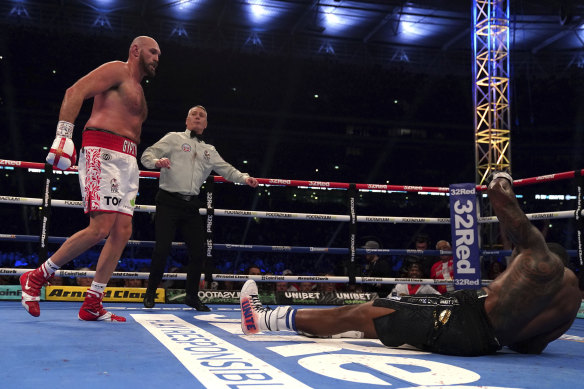 Fury knocks down Whyte to win the WBC heavyweight title.