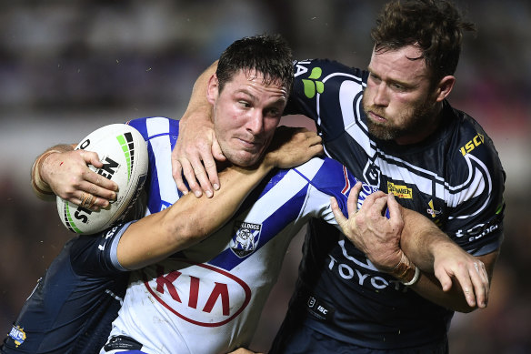 Josh Jackson of the Bulldogs is tackled by Gavin Cooper