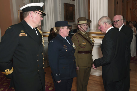 Prince Charles meets with honoured guests as High Commissioner for Australia George Brandis, right, looks on.