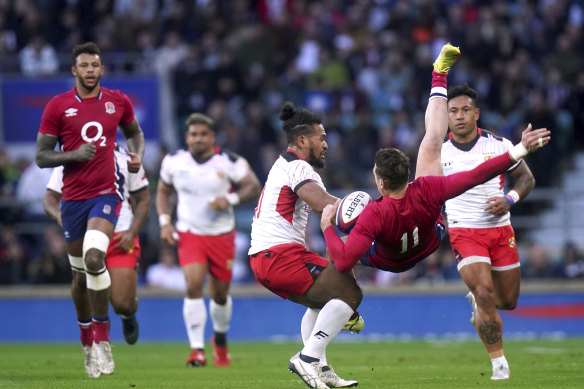 Tonga’s Solomone Kata, centre, tackles England’s Jonny May before being sin-binned.