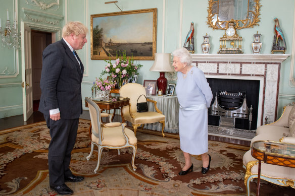 The Queen greets Prime Minister Boris Johnson in June at their first in-person weekly meeting since the start of the coronavirus pandemic.